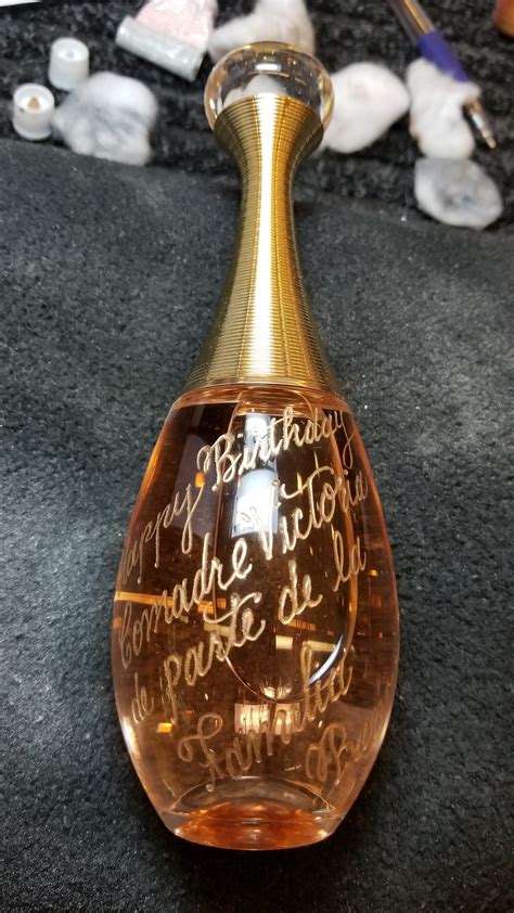 engraving on perfume bottle.